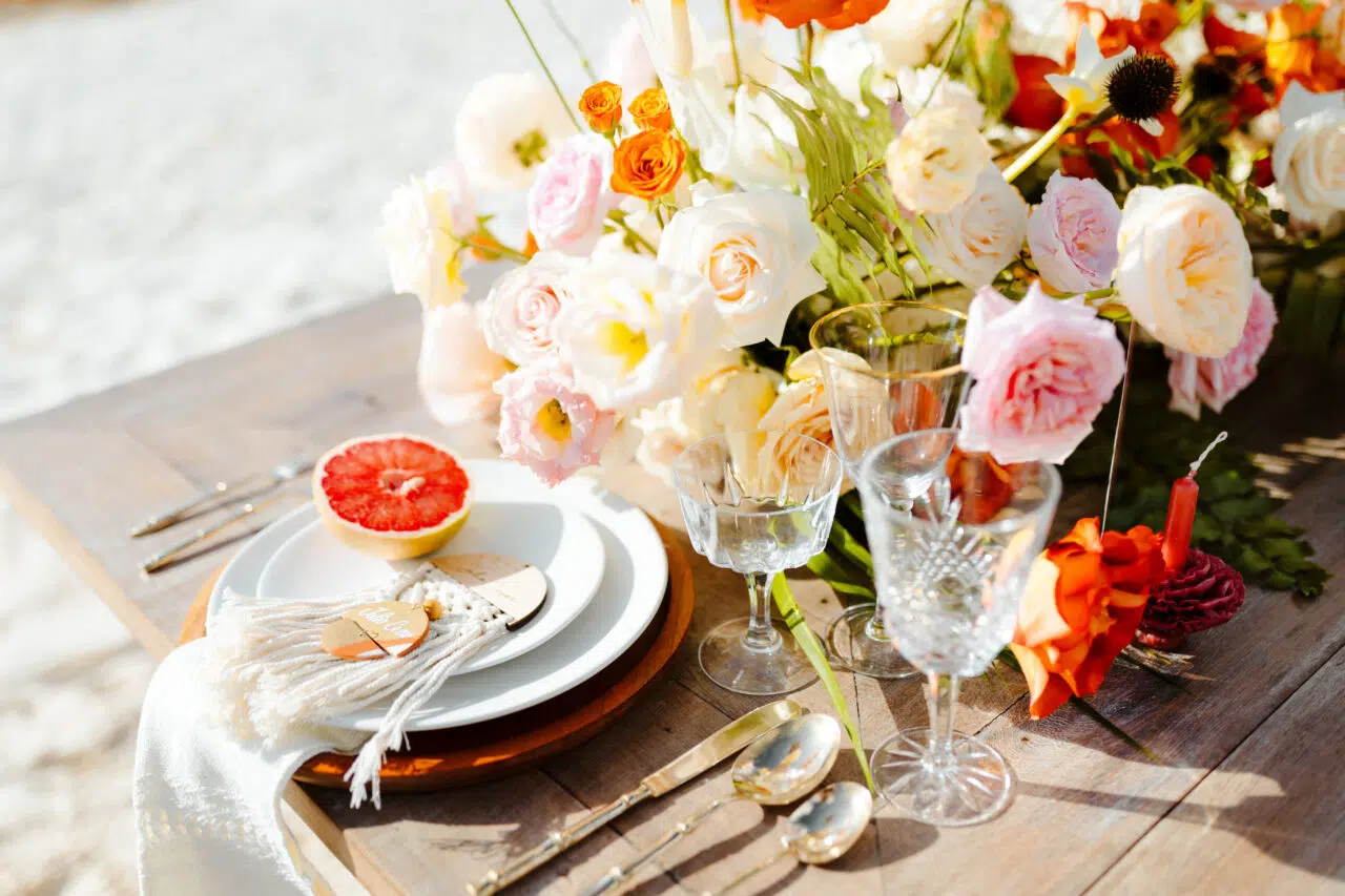 Boho table setting with fresh flowers on the beach